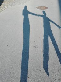 High angle view of couple shadow on street