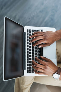 Midsection of woman using laptop