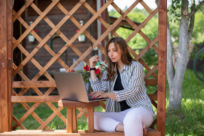 Man using mobile phone while sitting on chair