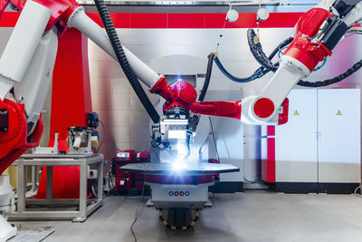 Automatic robots welding metal in factory