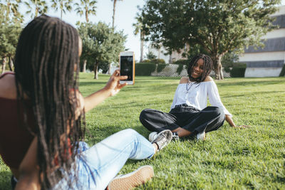 Women sitting on grass in field
