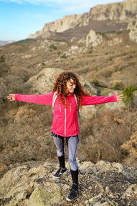 Full length of woman standing on rock