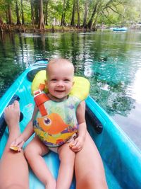 High angle view of boy sitting in lake