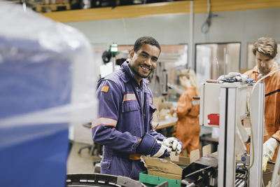 Portrait of smiling male blue-collar worker working in industry