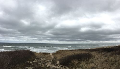 Scenic view of sea against cloudy sky