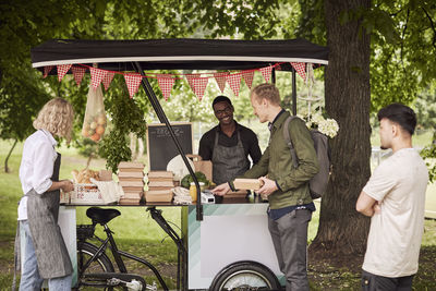 Clients buying food at food stall