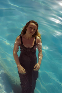 High angle portrait of young woman in swimming pool