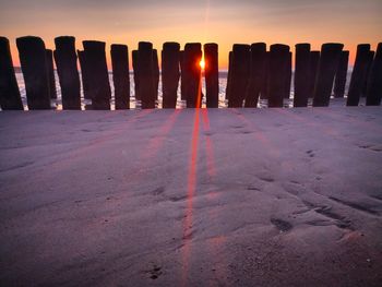 View of wooden posts at sunset