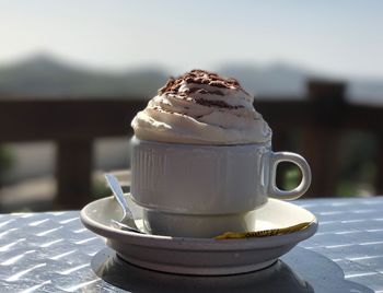 Close-up of coffee with whipped cream on table