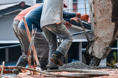 Low section of manual workers working at construction site