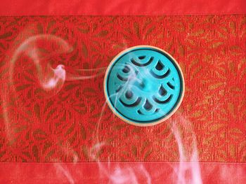 Close-up of red object on white surface