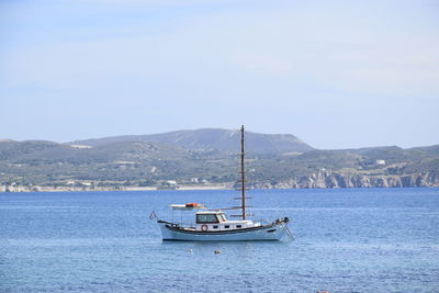 Sailboat sailing on sea against sky