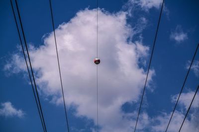 Low angle view of cables against blue sky