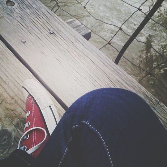 shoe, transportation, low section, personal perspective, high angle view, part of, person, mode of transport, footwear, one person, day, outdoors, cropped, wood - material, boat, nautical vessel, close-up, sunlight, river, bridge - man made structure