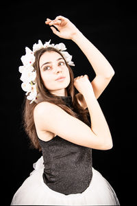 Portrait of a beautiful young woman over black background