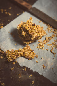 High angle view of broken oats bar with knife on table