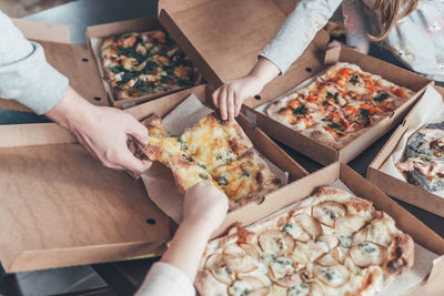 High angle view of people holding food on table