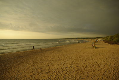 Scenic view of beach against sky during sunset