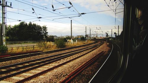 Train at railroad station against sky