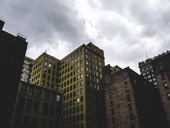 Low angle view of building against cloudy sky