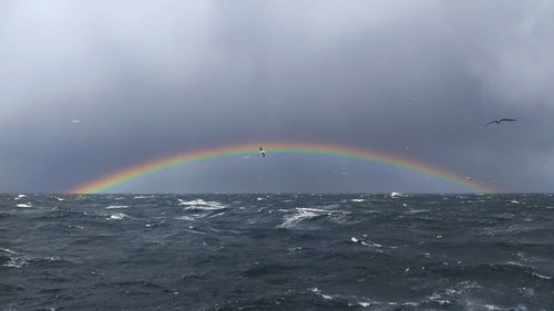 Rainbow over sea against sky