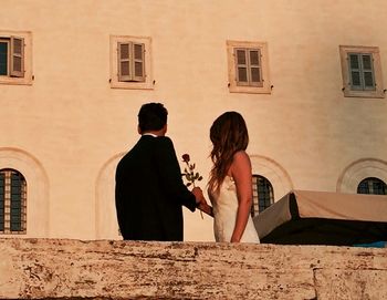 Woman standing by railing