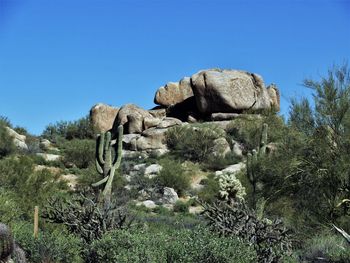 Rock formations against clear blue sky