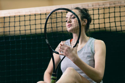 Low angle view of tennis player sitting on at court