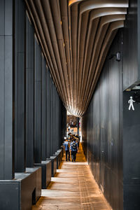 Rear view of woman walking in building