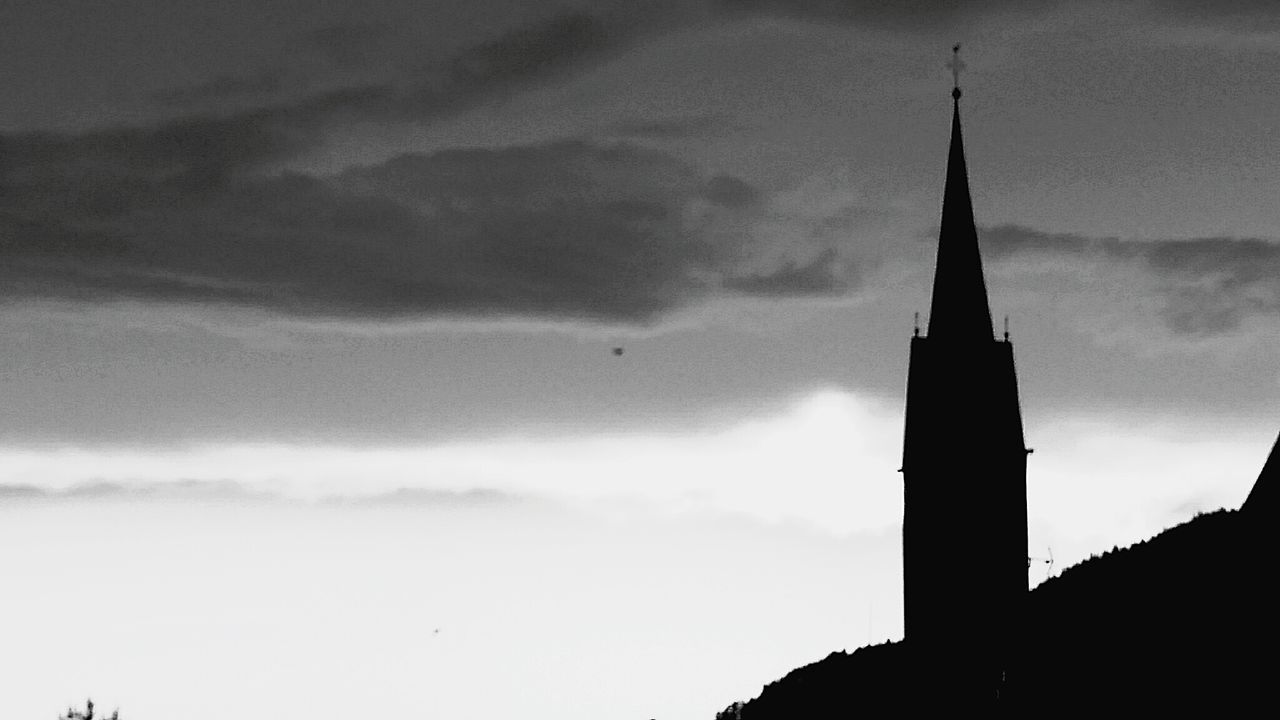 low angle view, architecture, sky, built structure, building exterior, cloud - sky, silhouette, cloudy, tower, cloud, dusk, bird, outdoors, high section, weather, religion, no people, church, tall - high