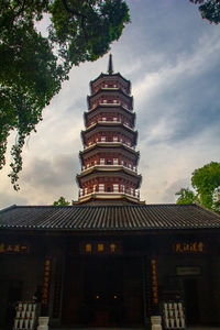 Low angle view of pagoda against sky in city