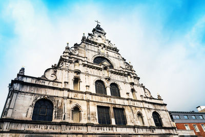 Low angle view of cathedral against cloudy sky