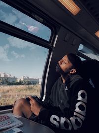 Man looking through car window