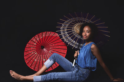 Full length of woman holding illuminated ferris wheel at night