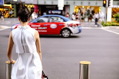 Woman looking at city street