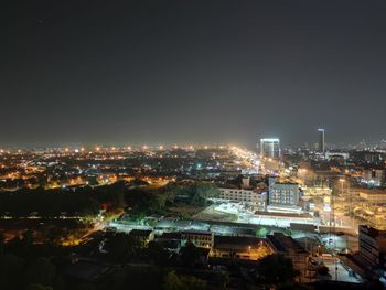 High angle view of illuminated city against sky at night