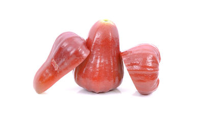 Close-up of red fruit over white background