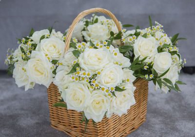 Close-up of white roses in basket