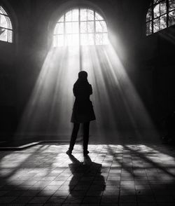 Woman standing on tiled floor