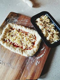 High angle view of pizza on cutting board