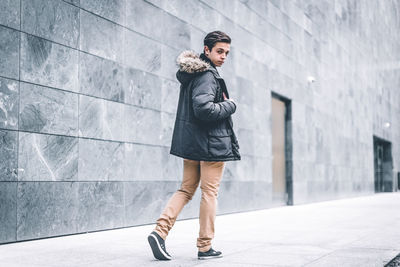 Full length portrait of young man in city