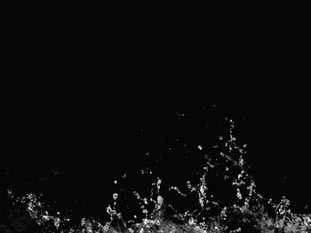 Water splashing against sky at night