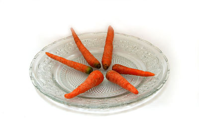 High angle view of orange fruit against white background