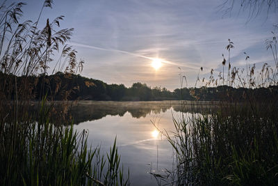 Scenic view of lake against sky during sunset