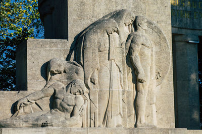 Statue of human on building wall