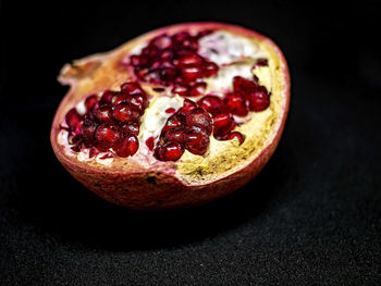 Close-up of strawberry on table against black background