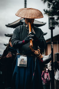 Full length of a man holding umbrella