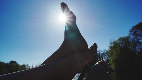 Low angle view of silhouette statue against sky on sunny day