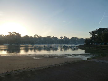 Scenic view of lake against sky at sunset