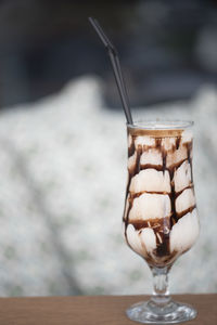 Close-up of chocolate milkshake in a glass on table